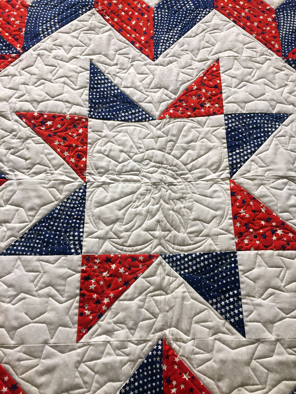 Detail of a red, white and blue embroidered quilt at the Iowa Quilt Museum in Winterset, Iowa