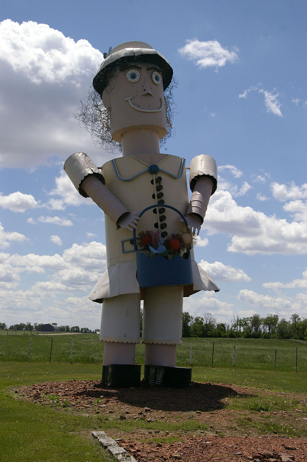 Large metal sculpture of woman holding a bucket of flowers along the Enchanted Highway near Regent, North Dakota