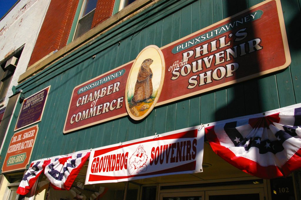 Red and green sign on the exterior of the Punxsutawney Chamber of Commerce and Phil's Official Souvenir Shop in Punxsutawney, Pennsylvania