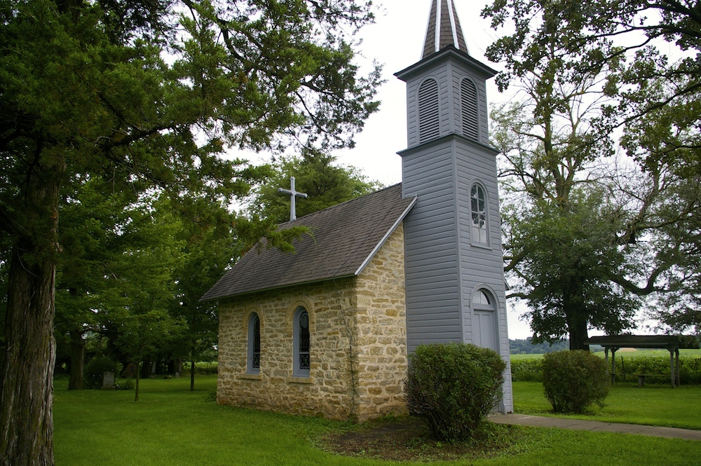 Brick and wood slat exterior of World's Smallest Church near Festina, Iowa