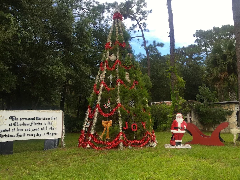 Christmas tree and Santa statue at Fort Christmas in Christmas, Florida
