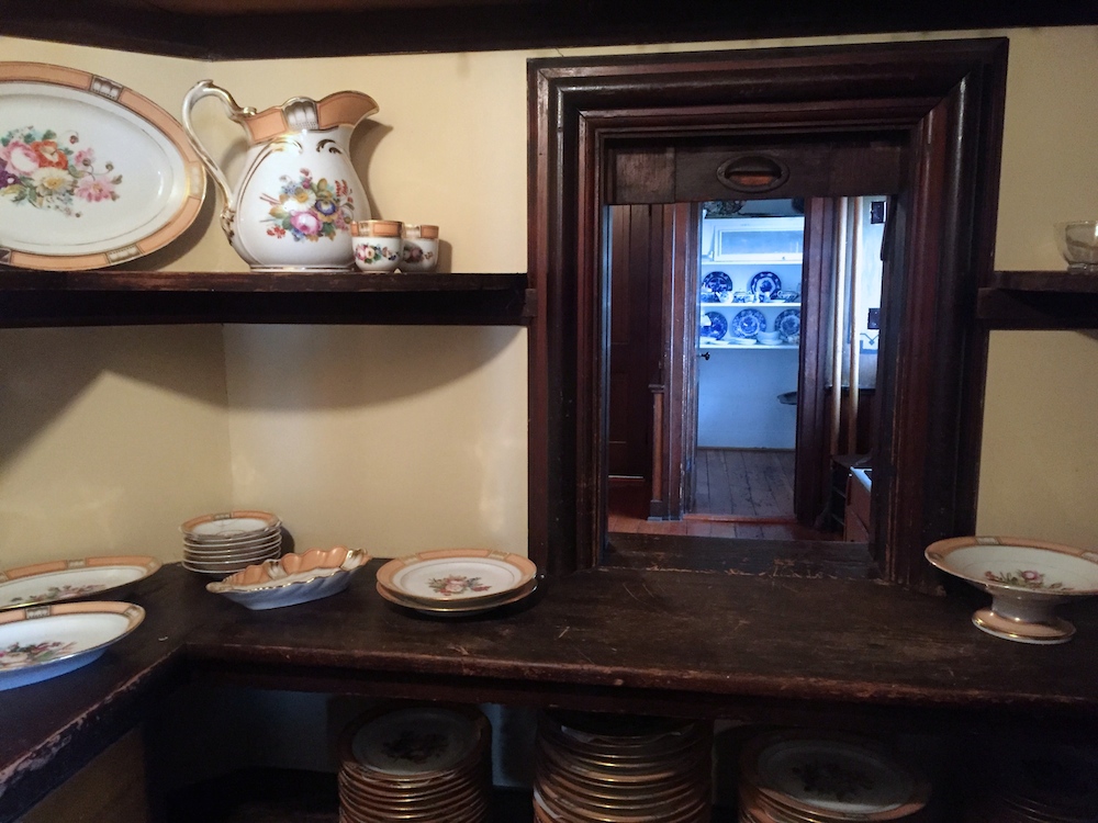 Dishes and servant passthrough inside the historic Tinker Swiss Cottage in Rockford, Illinois