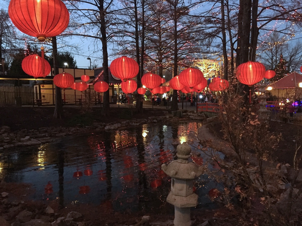 Red Chinese lanterns over a pond at Worlds of Fun's WinterFest in Kansas City, Missouri