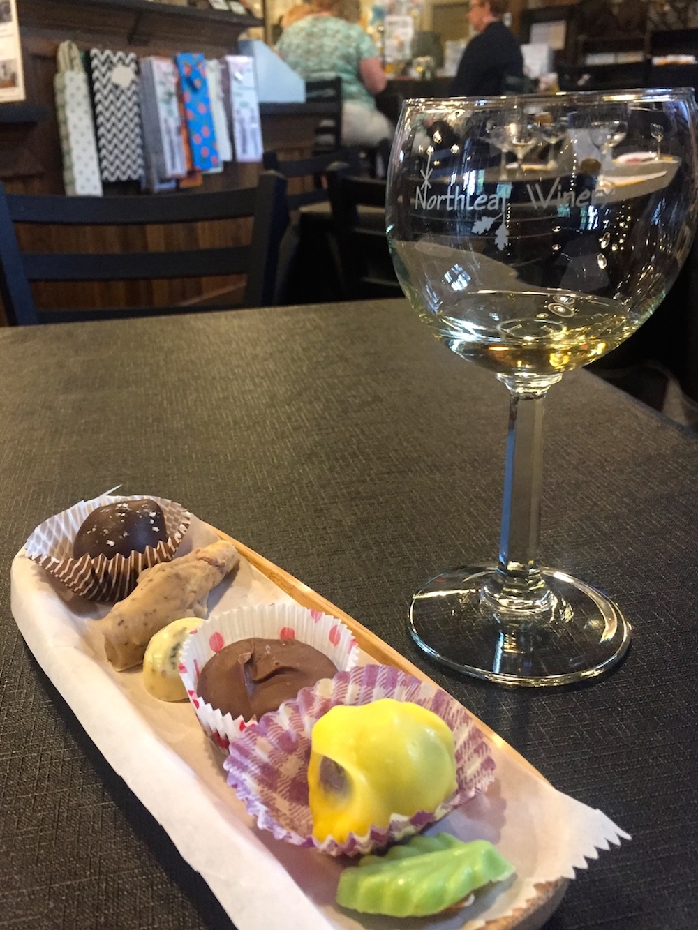 Glass of white wine paired with handmade chocolates at Northleaf Winery near Janesville, Wisconsin