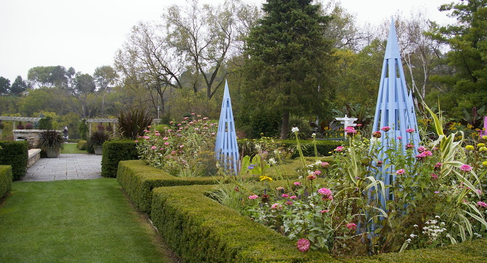 Hedges with flowers and blue trellis at the Rotary Botanical Gardens in Janesville, Wisconsin