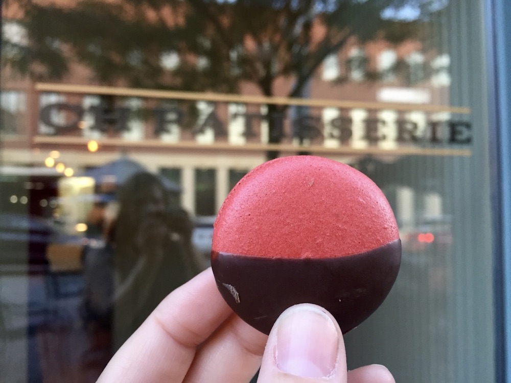 Chocolate raspberry French macaron in front of the window of CH Patisserie in downtown Sioux Falls, South Dakota