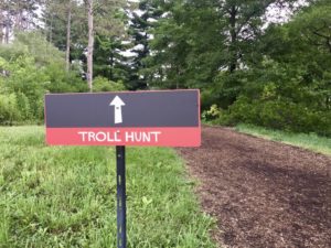 Black and red sign for Troll Hunt at the Morton Arboretum in Lisle, Illinois