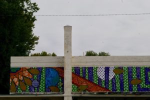 Colorful mural on the top of white brick building in Wichita, Kansas