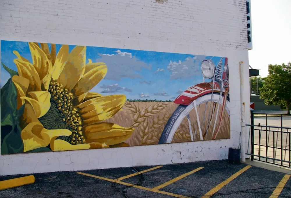 Sunflower mural with bike and field of sunflowers in the Douglas Design District in Wichita, Kansas