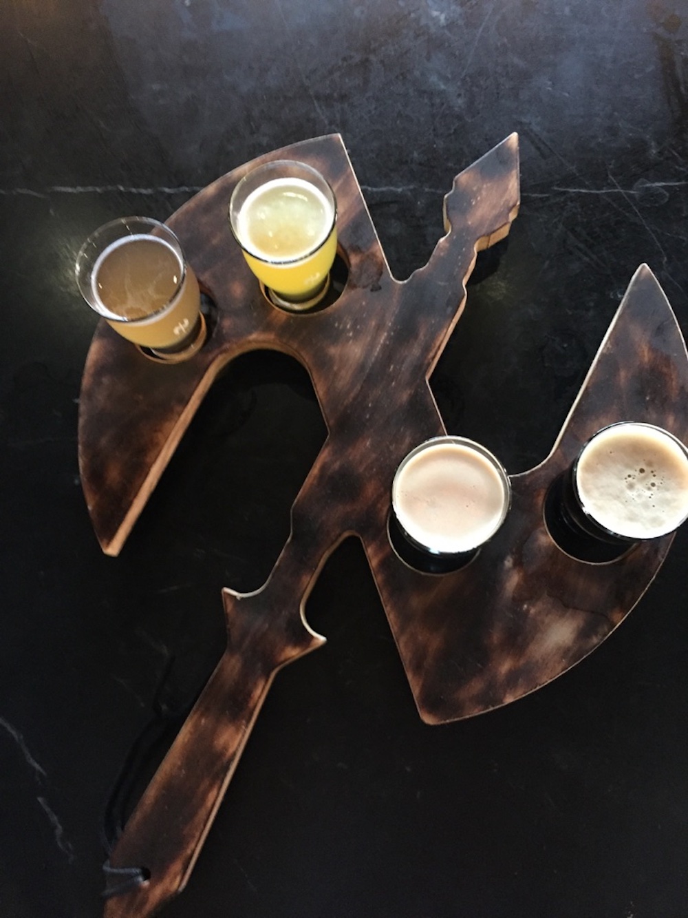 Flight of beers in a battle axe shaped folder at Nortons Brewing Company in Wichita, Kansas