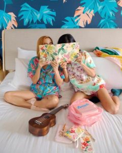 Two girls reading ban.do travel planner