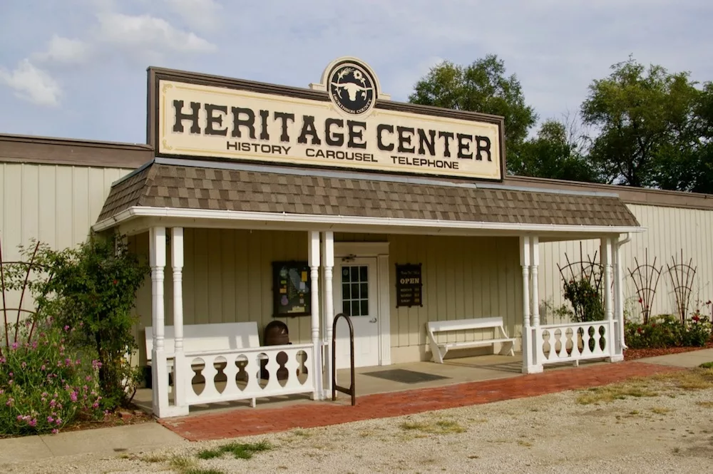 Small building with exterior porch and sign that reads Heritage Center at the Dickinson County Heritage Center in Abilene, Kansas