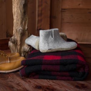 Grey wool Glerup boots with red flannel blanket