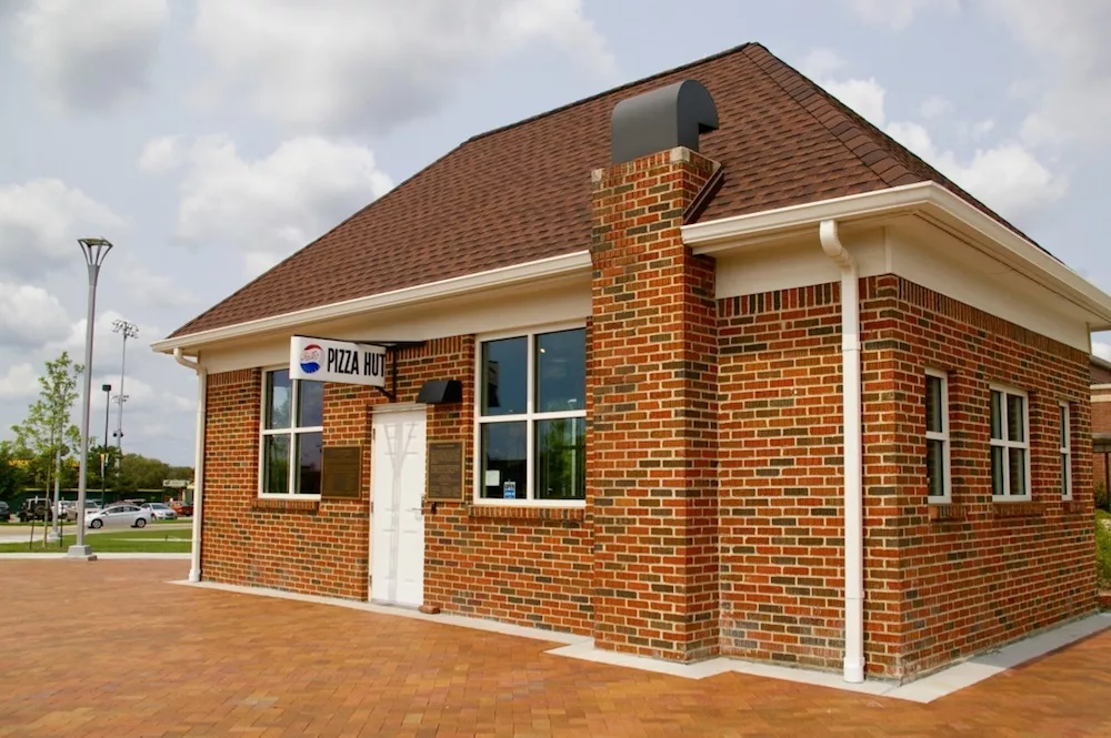 Exterior of small brown brick building that housed the first Pizza Hut on the campus of Wichita State University in Wichita, Kansas