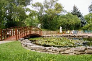 Gardens and bridge over lily pond at the Seelye Mansion in Abilene, Kansas