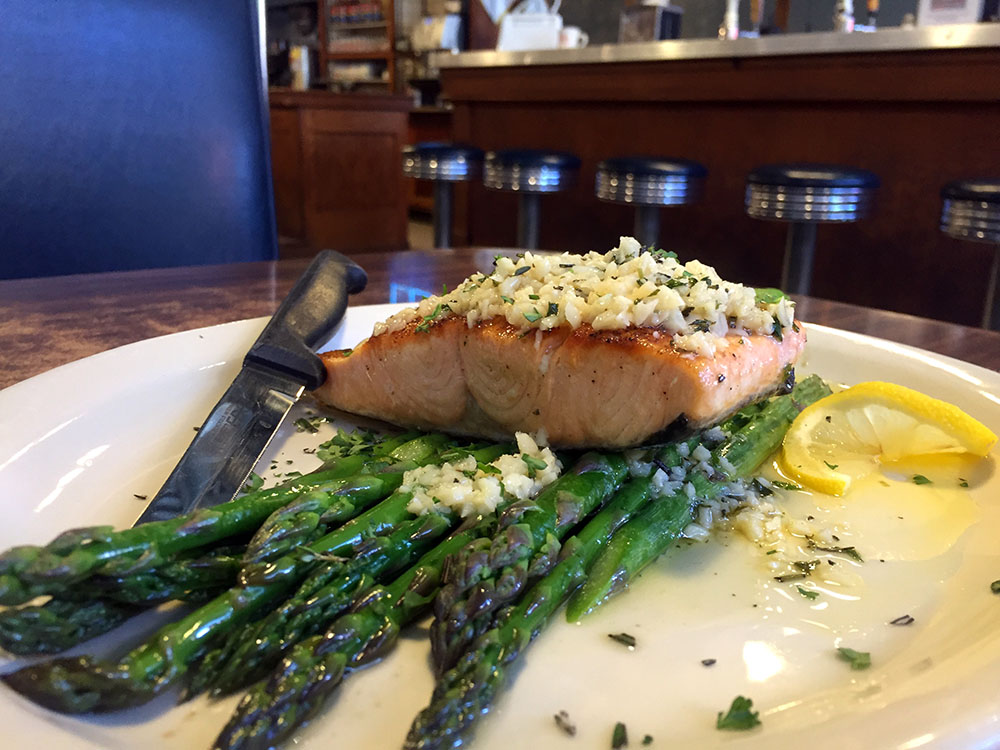 Salmon de Burgo on top of asparagus on a plate at the Northside Cafe in Winterset, Iowa