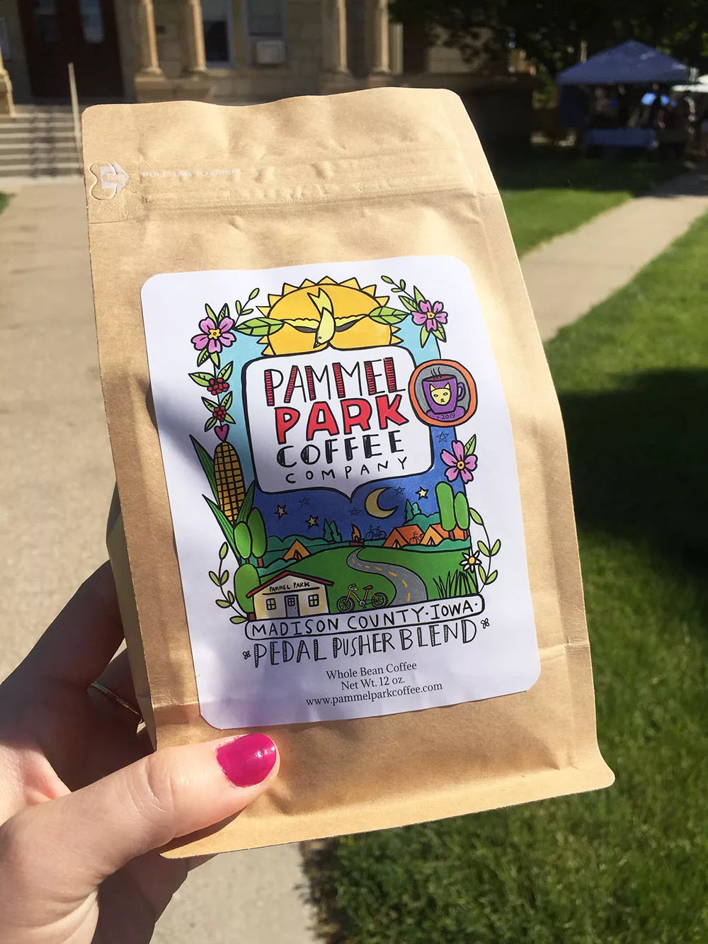 Bag of coffee beans from Pammel Park Coffee with colorful illustrated label at the Winterset Farmers' Market in Winterset, Iowa