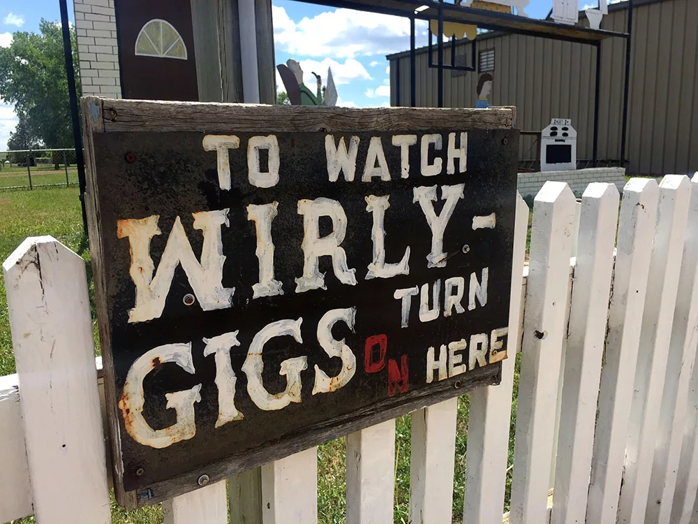 Sign reading "To Watch Wirly Gigs on Turn Here" in Regent, North Dakota