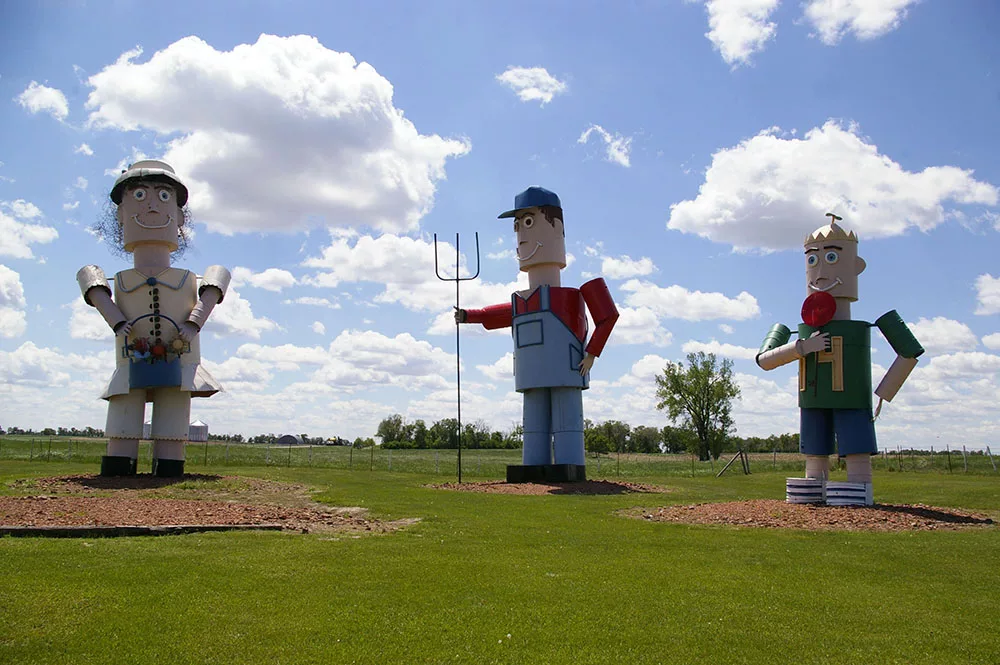 Large metal sculptures of three people along the Enchanted Highway near Regent, North Dakota