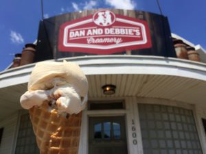 Caramel ice cream cone in front of Dan & Debbie's sign in Ely, Iowa