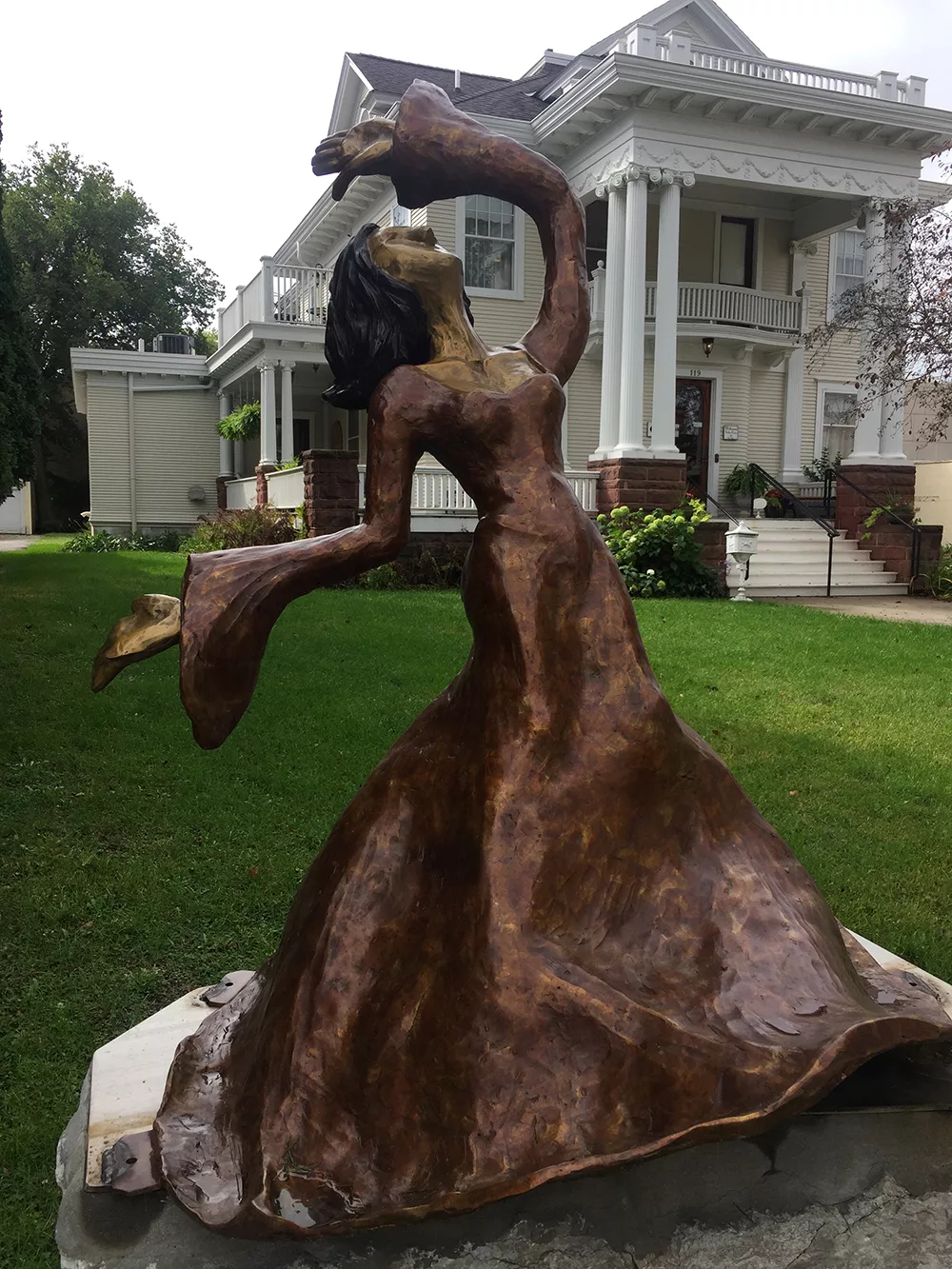 Bronze sculpture of woman dancing on the River City Sculptures on Parade in Mason City, Iowa