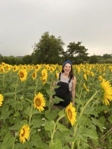 Woman in field of sunflowers at Badger Creek State Recreation Area in Van Meter, Iowa