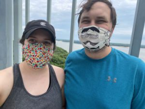 Two people wearing masks at the top of the Cordova Park Observation Tower near Lake Red Rock in Knoxville, Iowa