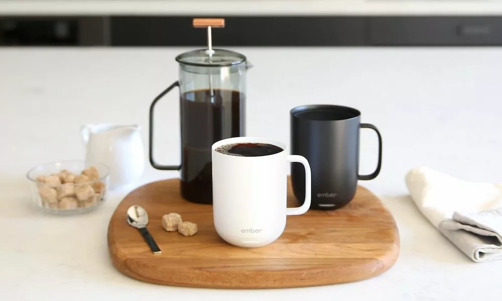 Two Ember mugs on a tray with a coffee French press
