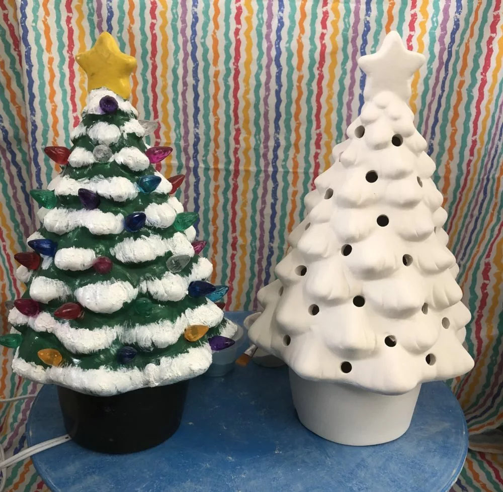 Two ceramic Christmas trees—one painted and one not painted