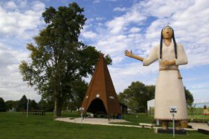 Statue of the World's Largest Pocahontas next to a giant metal teepee in Pocahontas, Iowa