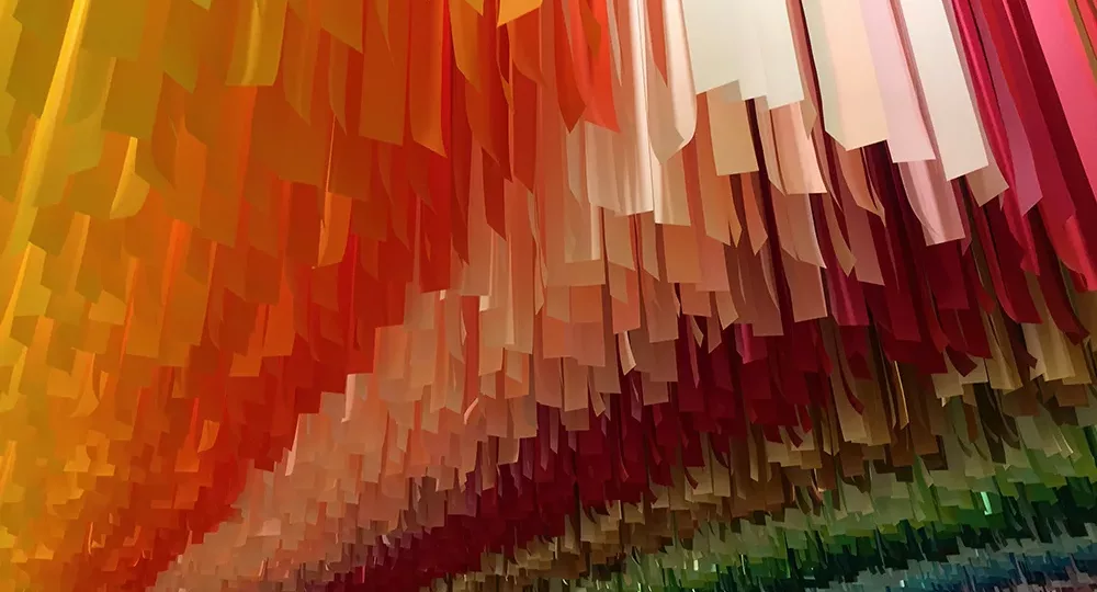 Rainbow streamer installation at the Color Factory in New York City, New York
