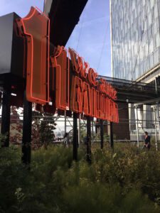 Red neon art installation that says "We are 11 million" along the High Line in New York City