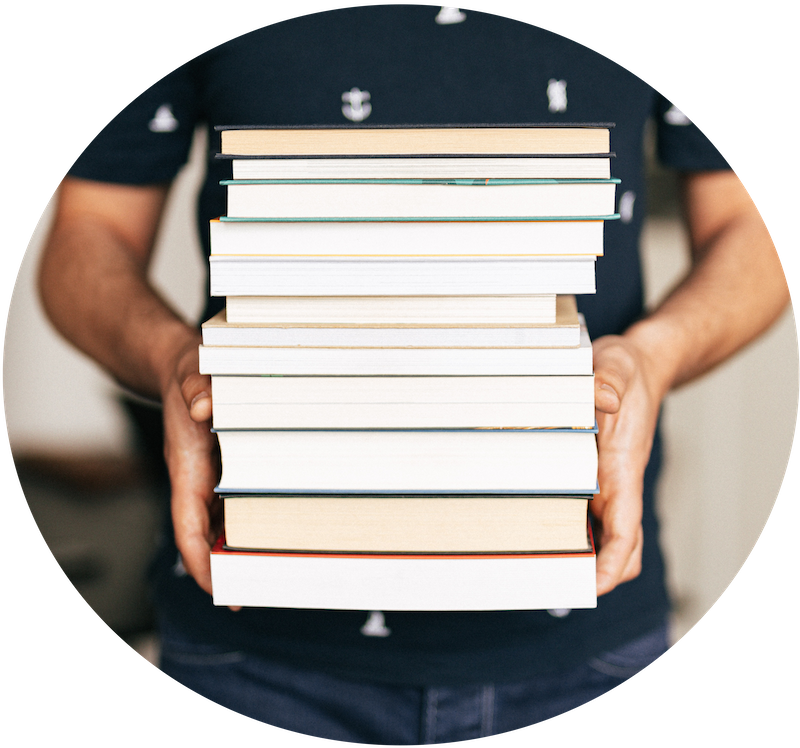 Image of person holding a stack of books