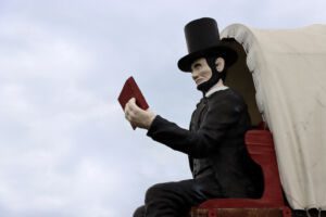 Giant statue of Abraham Lincoln reading a book at the World's Largest Covered Wagon located on Route 66 in Lincoln, Illinois