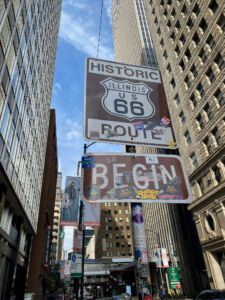 Historic Begin Route 66 sign in downtown Chicago on E. Adams Street and Michigan Avenue