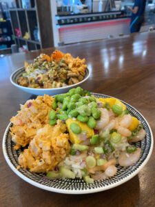 Two poke bowls with toppings at Crafted in Wichita, Kansas