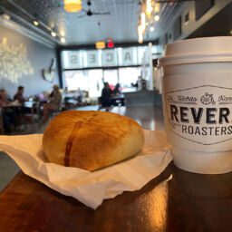 Savory breakfast hand pie and coffee cup on the counter at Reverie Roasters in Wichita, Kansas