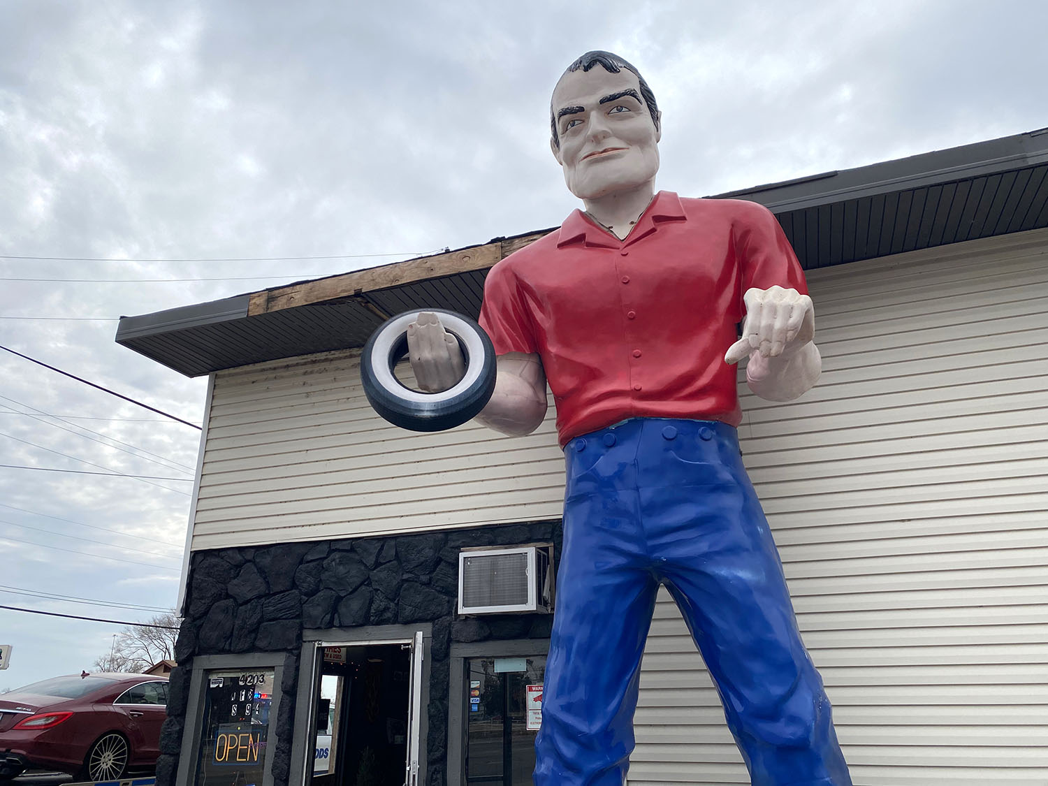 Muffler Man statue holding small tire in front of Brown's Tires in Wichita, Kansas