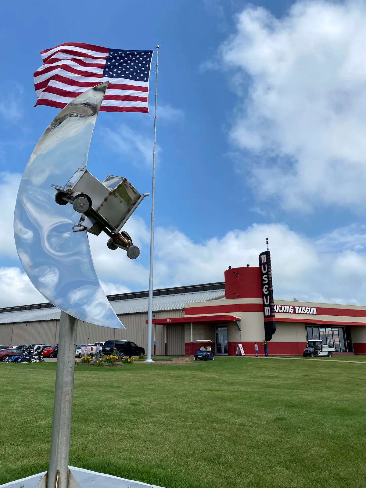 Sculpture and American flag in front of Iowa 80 Trucking Museum at the World's Largest Truckstop in Walcott, Iowa