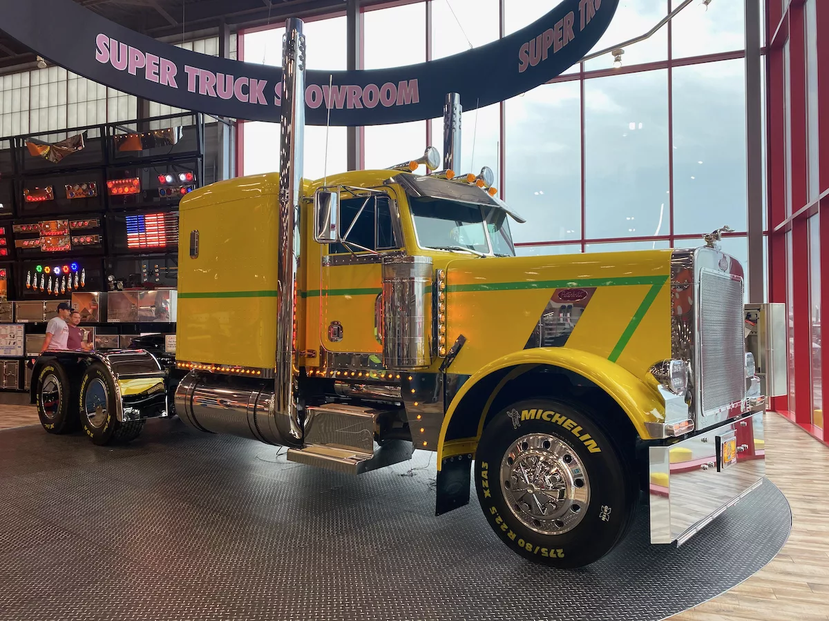 Giant yellow truck on a rotating platform in the Super Truck Showroom at the World's Largest Truckstop in Walcott, Iowa