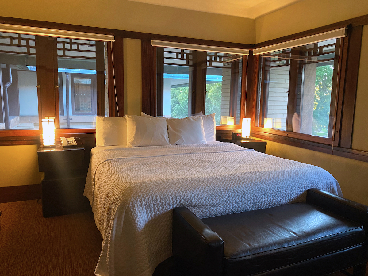 Bed in guest room overlooking Central Park in the Frank Lloyd Wright-designed Historic Park Inn Hotel in Mason City, Iowa
