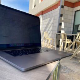MacBook computer on table outside of Home2Suites northeast in Wichita, Kansas