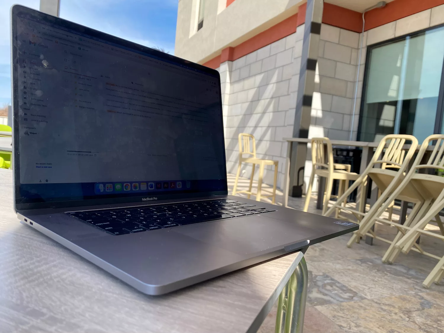 MacBook computer on table outside of Home2Suites northeast in Wichita, Kansas