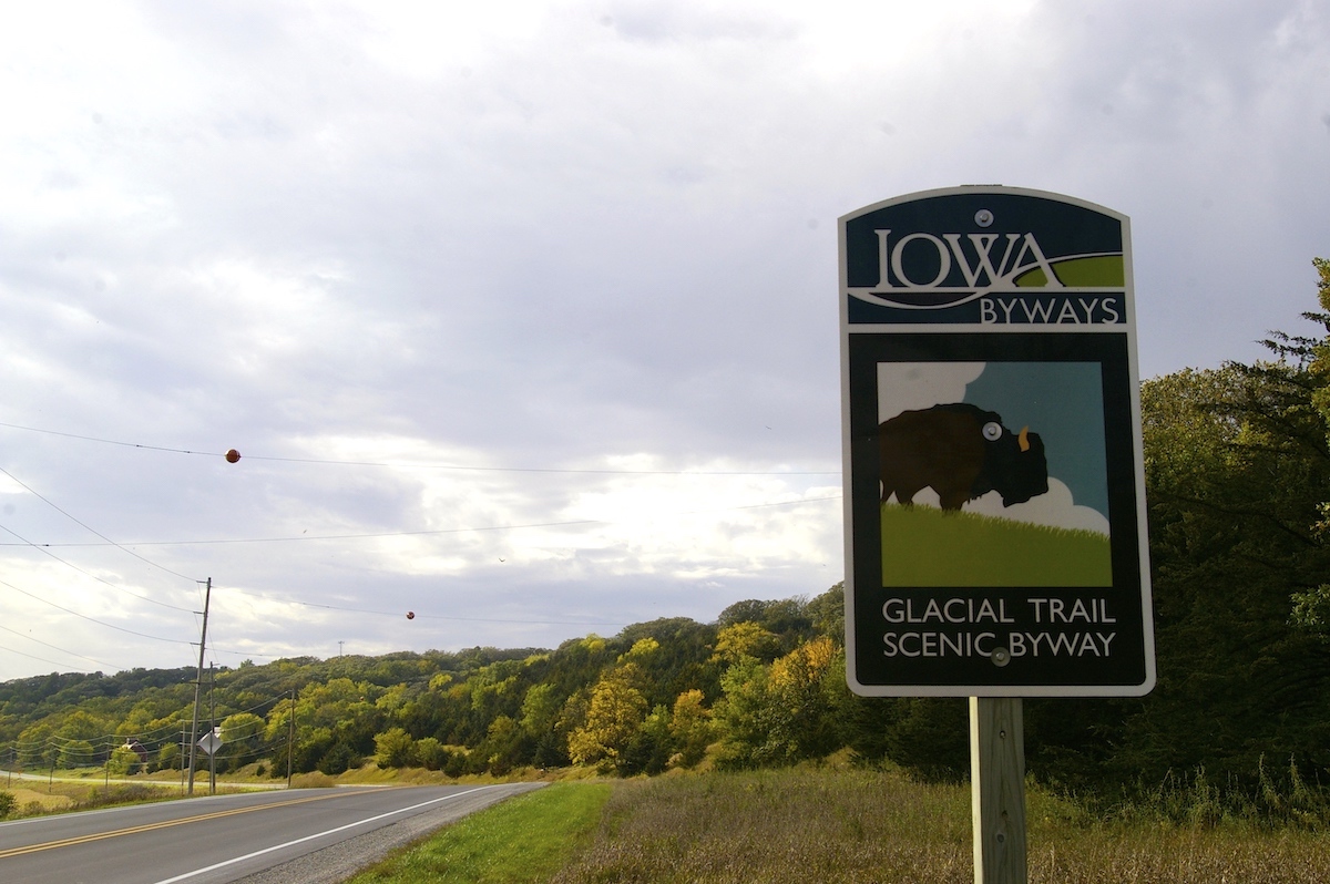 Signage for Glacial Trail Scenic Byway against colorful autumn leaves