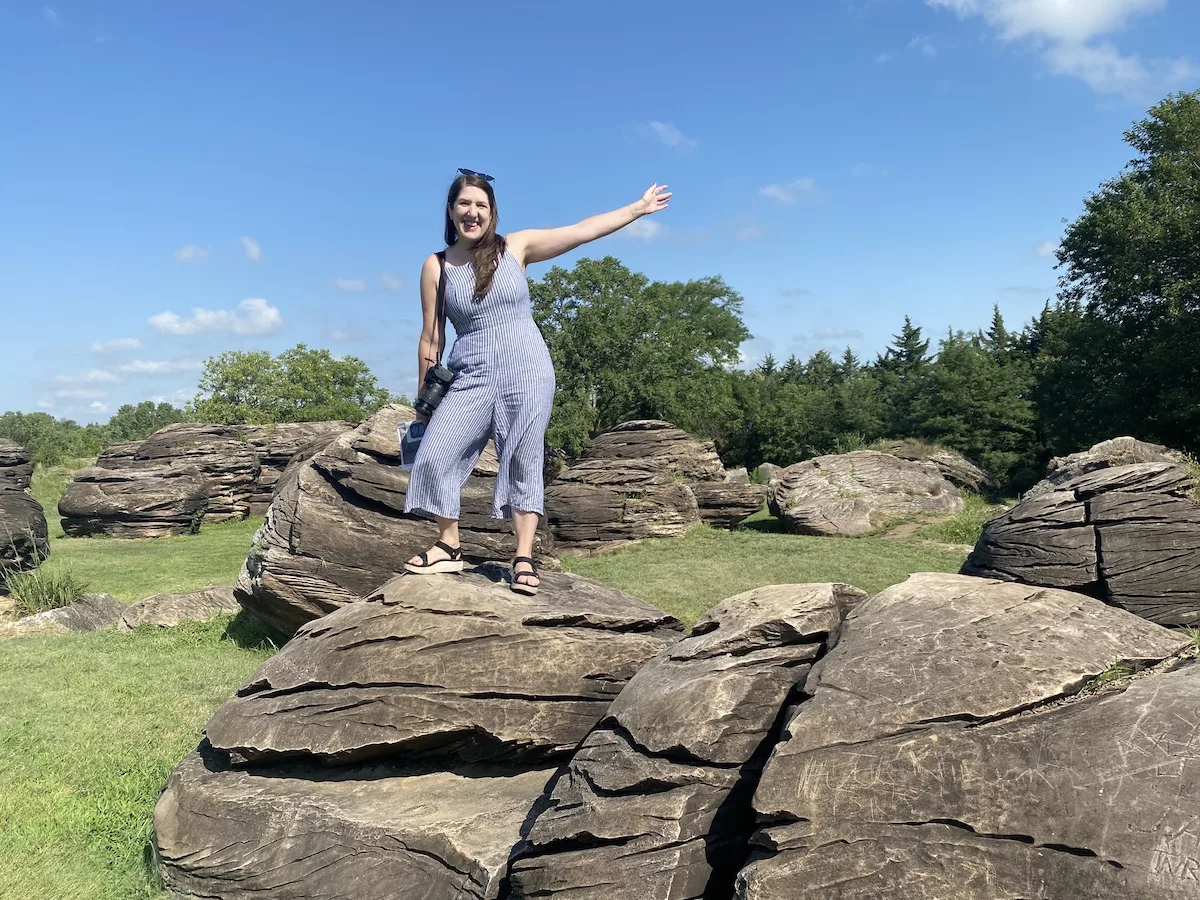 Woman standing on sandstone concretions at Rock City Park in Minneapolis, Kansas