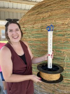 Woman adding twine to World's Largest Ball of Twine in Cawker City, Kansas