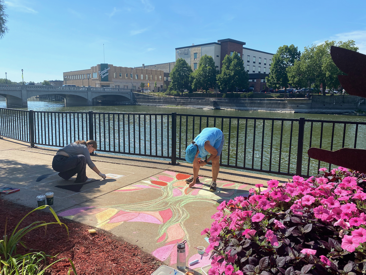 People making chalk art during Art Infusion in Janesville, Wisconsin
