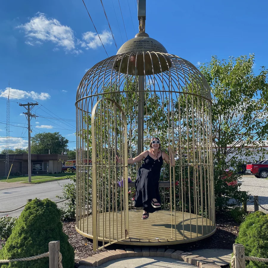 Woman sitting in Big Birdcage in Casey, Illinois