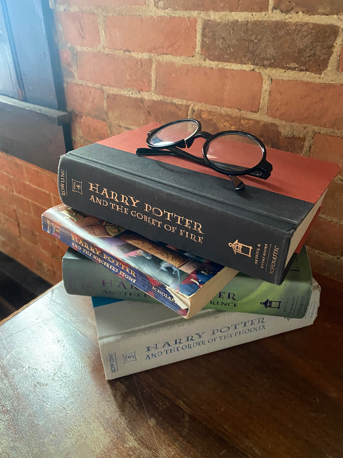 Stack of Harry Potter books with glasses in Room 303 at the Eighteen-Ninety Sleepover in Casey, Illinois