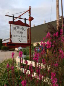 Flowers and sign at exterior of Richards Farm Restaurant in Casey, Illinois
